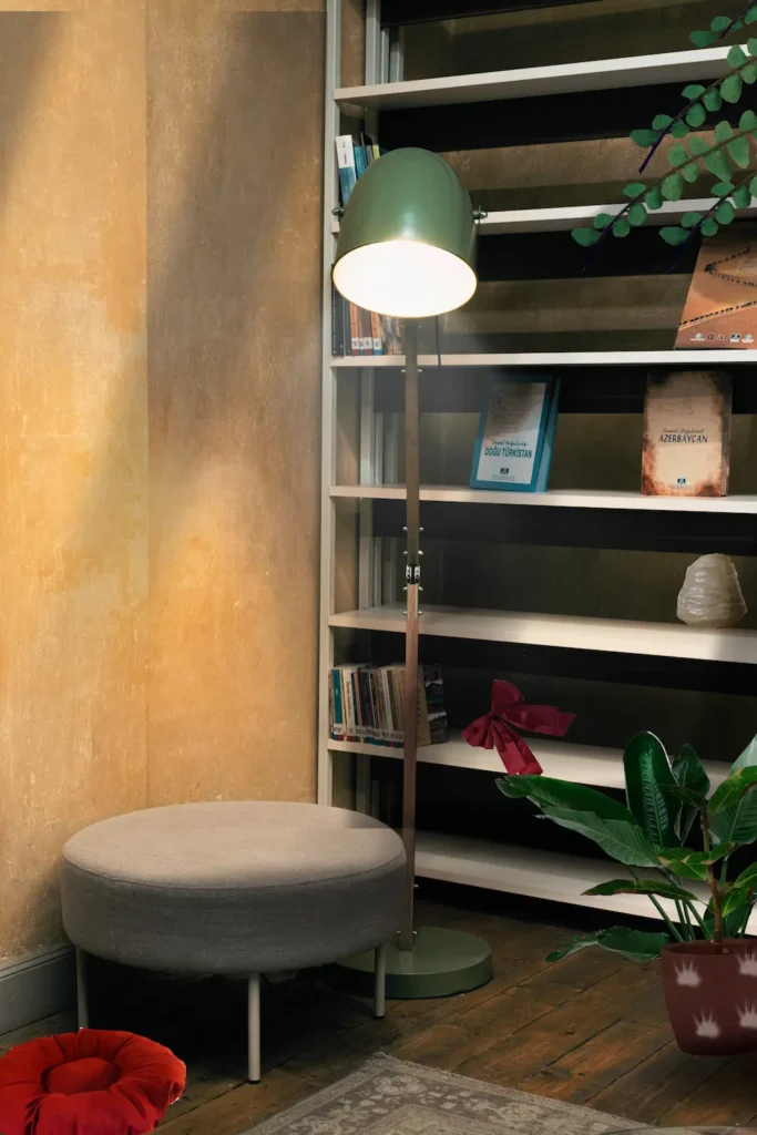 Green Lamp next to the bookcase with plants